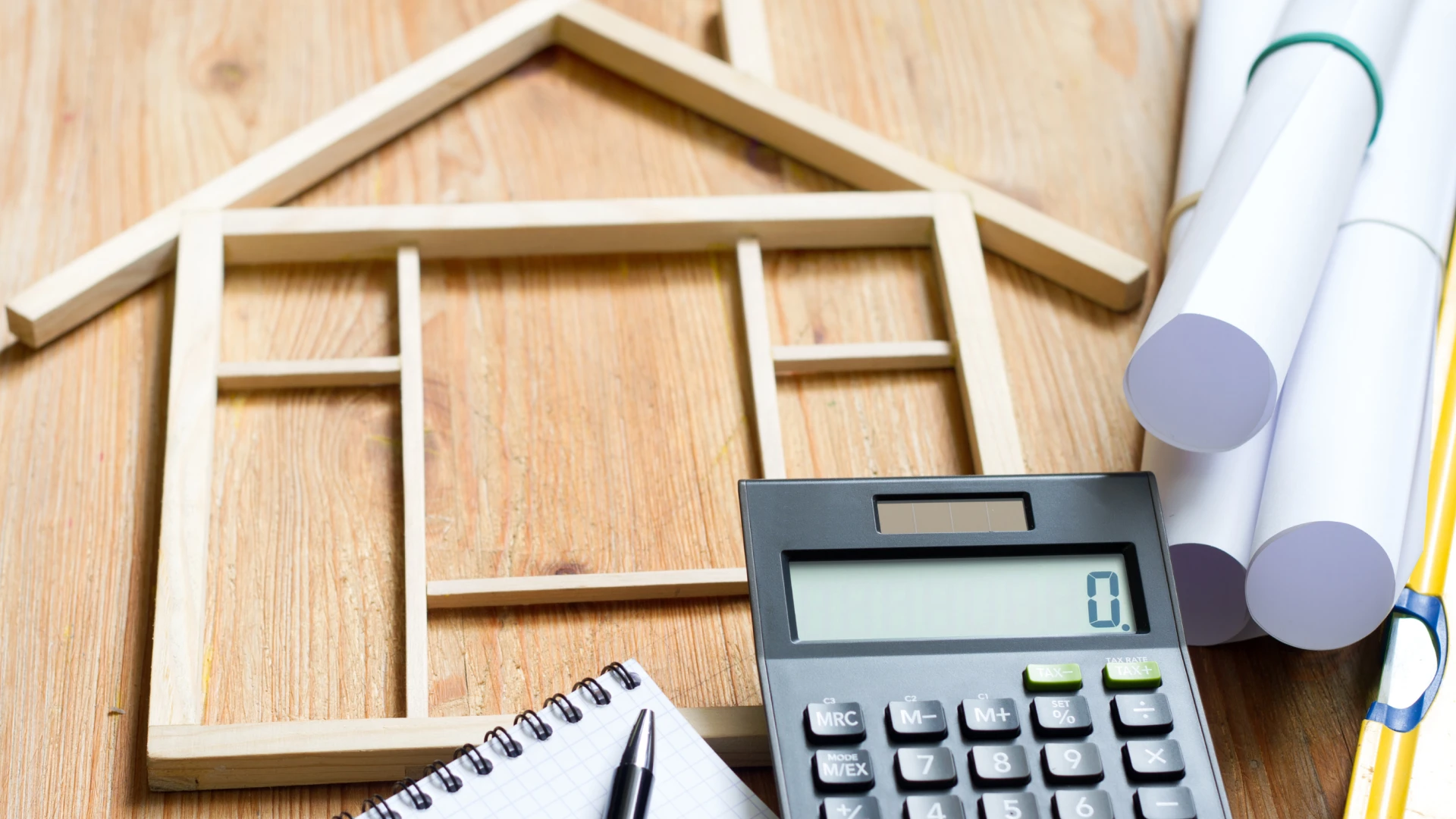 Wooden House with calculator And blueprint